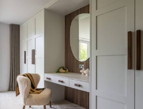 In Frame panelled doors with walnut handles, full size fitted wardrobes by Kestrel Kitchens