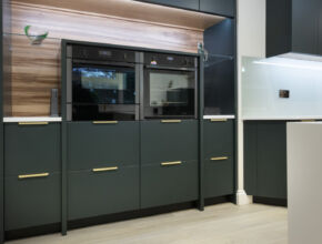 Studio Green kitchen cabinets with brass handles